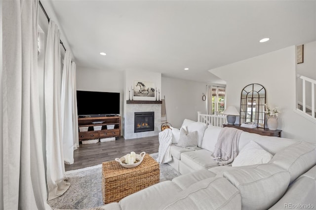 3535 Raintree Ln, Dacono, CO 80514 - living area with wood finished floors, a fireplace, recessed lighting, and stairs