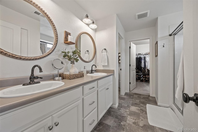 3535 Raintree Ln, Dacono, CO 80514 - bathroom featuring double vanity, tiled shower, and a walk in closet