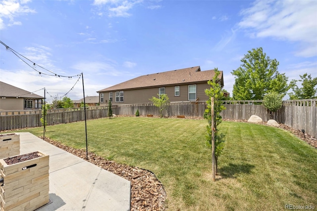 3535 Raintree Ln, Dacono, CO 80514 - fenced backyard featuring a patio and a fire pit
