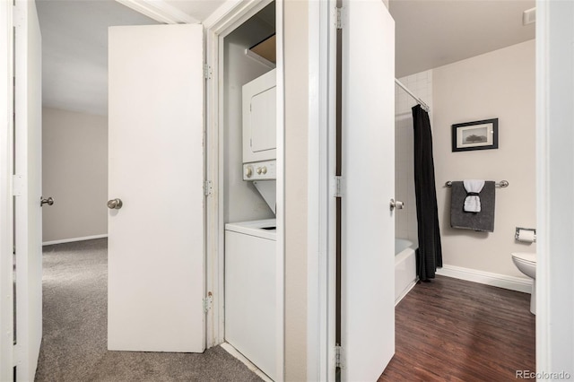 5300 E Cherry Creek S Drive 324, Denver, CO 80246 - washroom featuring estacked washer and dryer and dark wood finished floors
