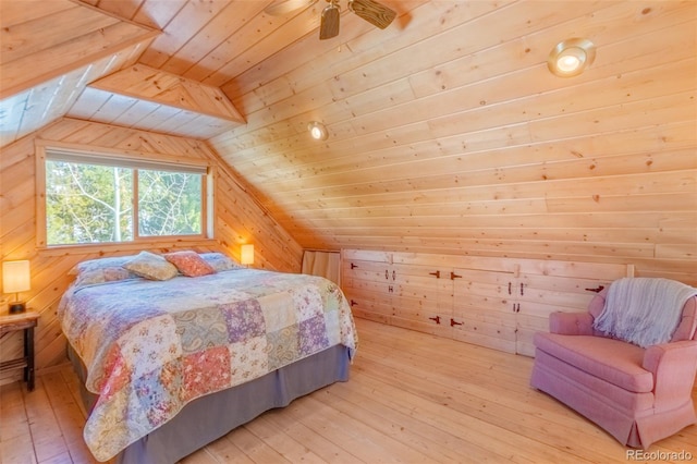 bedroom featuring lofted ceiling, wood walls, wood ceiling, and light wood-style floors