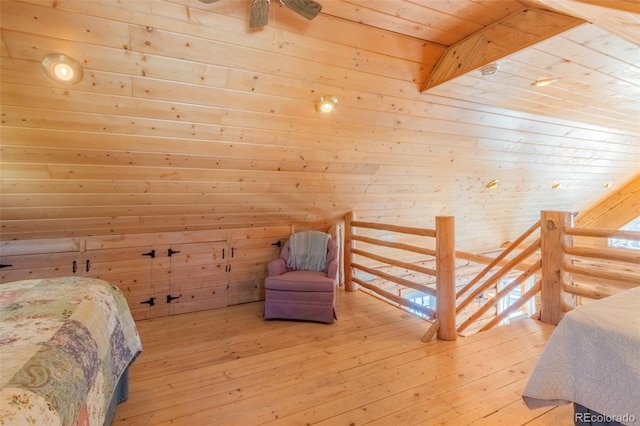 bedroom featuring wooden ceiling, hardwood / wood-style floors, and wood walls