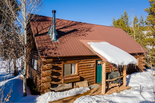 exterior space with metal roof and log exterior