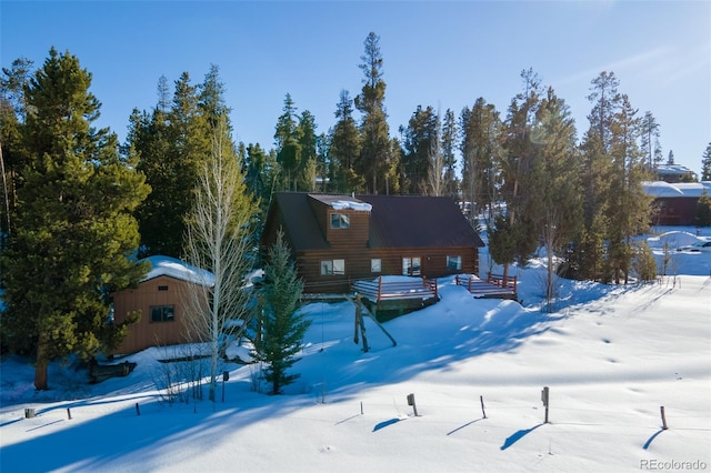 exterior space featuring an outdoor structure and log siding