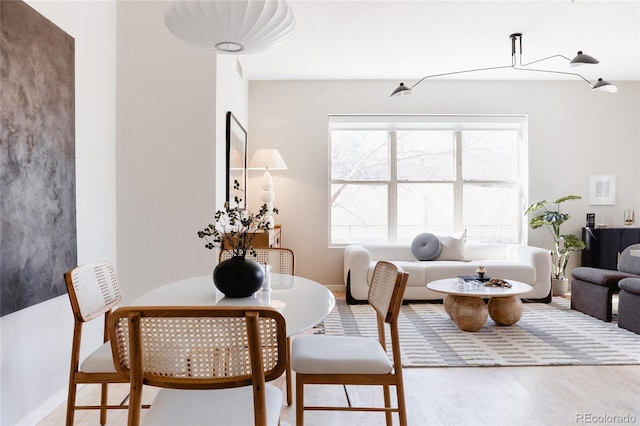 dining area featuring baseboards and wood finished floors