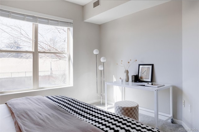 unfurnished bedroom with carpet flooring, visible vents, and baseboards