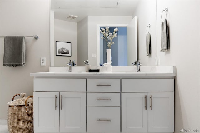 bathroom featuring double vanity, visible vents, and a sink