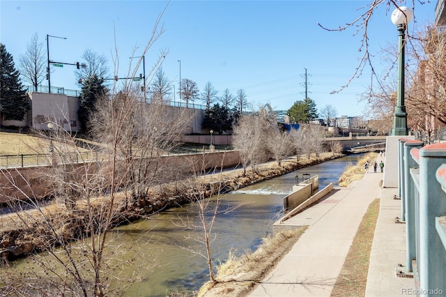 view of street with sidewalks and a water view