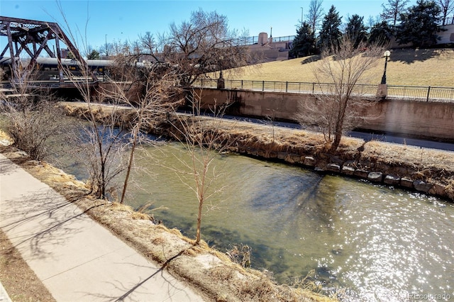 property view of water featuring fence