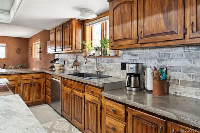 96 County Road 7, Fairplay, CO 80440 - kitchen with stainless steel dishwasher, backsplash, brown cabinets, and a sink