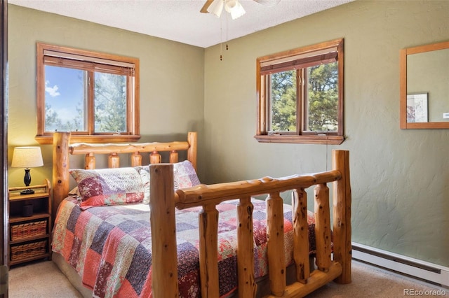 96 County Road 7, Fairplay, CO 80440 - bedroom featuring a textured wall, baseboards, baseboard heating, a ceiling fan, and carpet