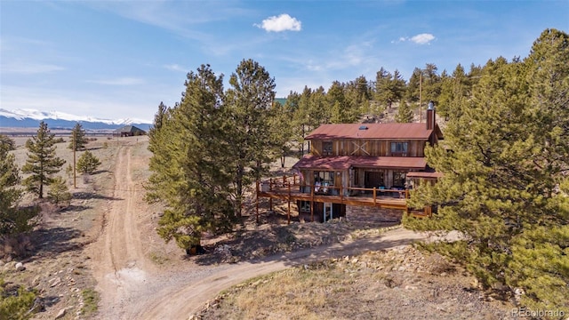 96 County Road 7, Fairplay, CO 80440 - back of house with a wooden deck and a chimney