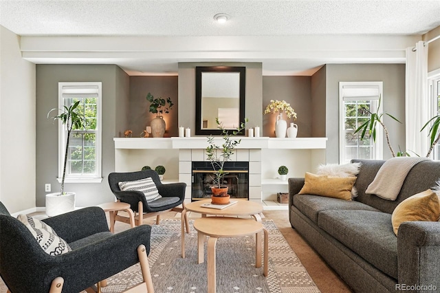 living area with a fireplace and a textured ceiling