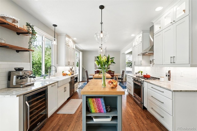 kitchen featuring beverage cooler, open shelves, wall chimney range hood, appliances with stainless steel finishes, and tasteful backsplash