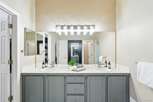 full bathroom with double vanity and a sink