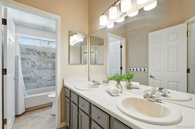 bathroom with a sink, double vanity, and toilet