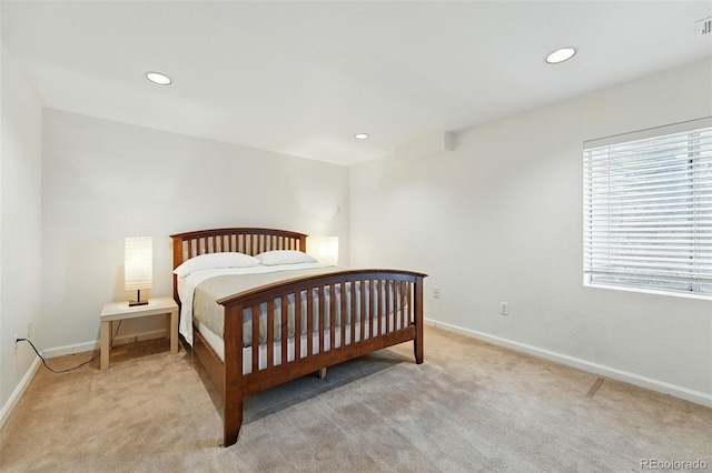 carpeted bedroom featuring baseboards and recessed lighting