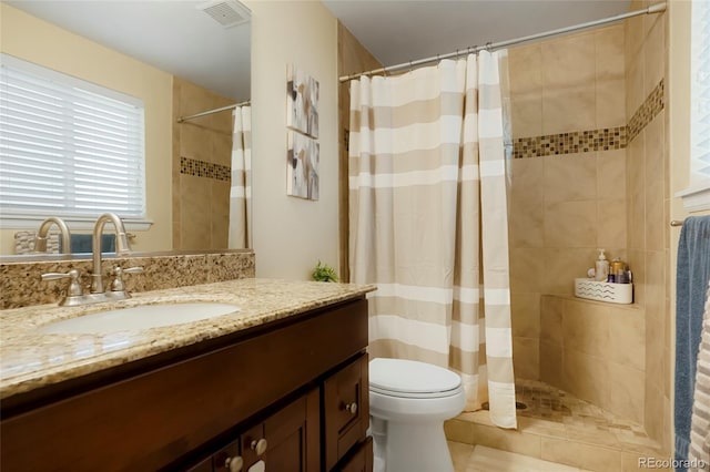 2964 S Akron St, Denver, CO 80231 - bathroom with vanity, tiled shower, and toilet