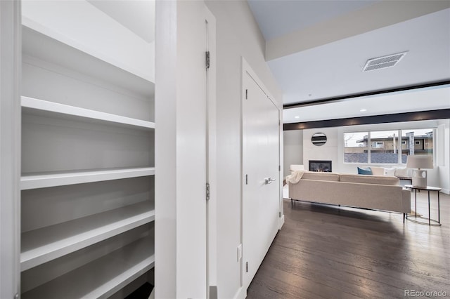 corridor with visible vents and hardwood / wood-style floors