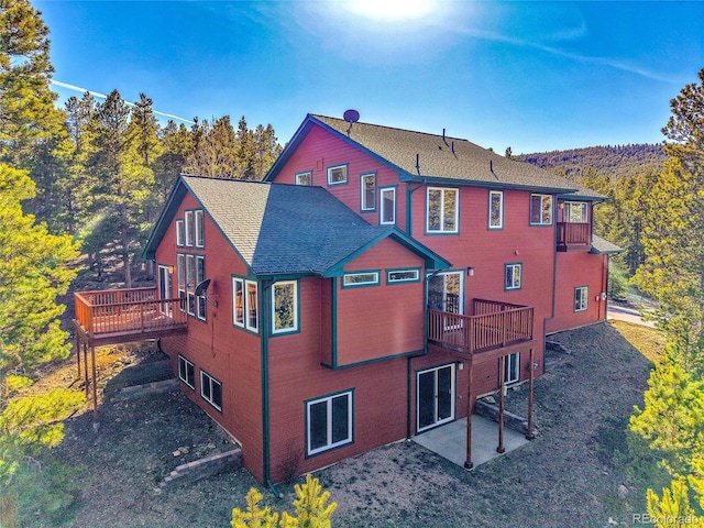 398 Mountain View Dr, Black Hawk, CO 80422 - rear view of house featuring a patio area, a deck, and roof with shingles