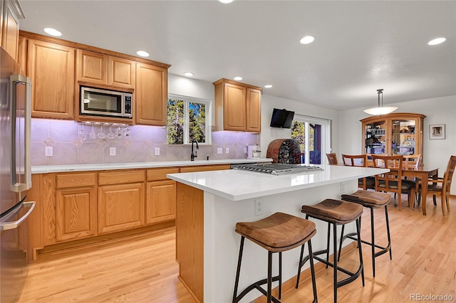398 Mountain View Dr, Black Hawk, CO 80422 - kitchen with appliances with stainless steel finishes, light wood finished floors, light countertops, decorative backsplash, and recessed lighting