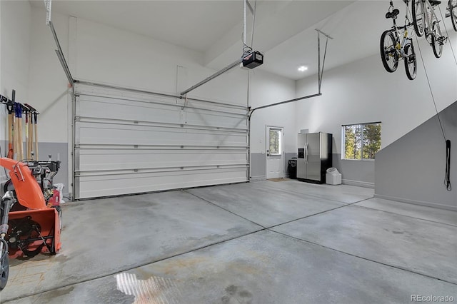 398 Mountain View Dr, Black Hawk, CO 80422 - garage with stainless steel fridge with ice dispenser, a garage door opener, and baseboards