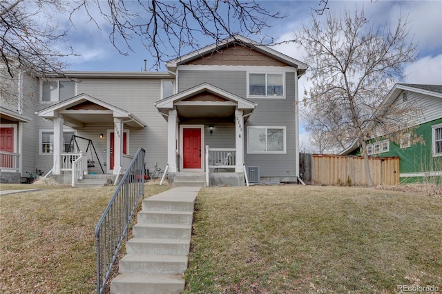 view of front of house featuring a front yard, fence, and central air condition unit