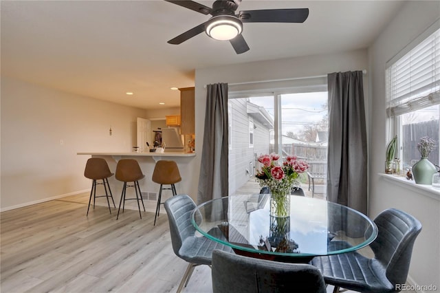 dining area with recessed lighting, light wood-style flooring, and baseboards