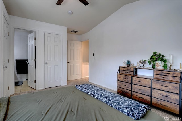 carpeted bedroom featuring lofted ceiling, baseboards, visible vents, and ensuite bathroom