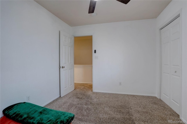 carpeted bedroom featuring ceiling fan and baseboards