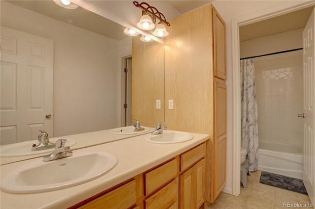 bathroom featuring double vanity, tile patterned flooring, and a sink