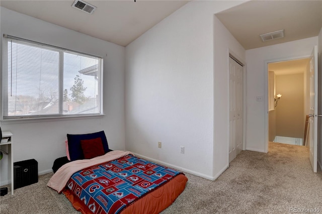 carpeted bedroom with visible vents, vaulted ceiling, and baseboards