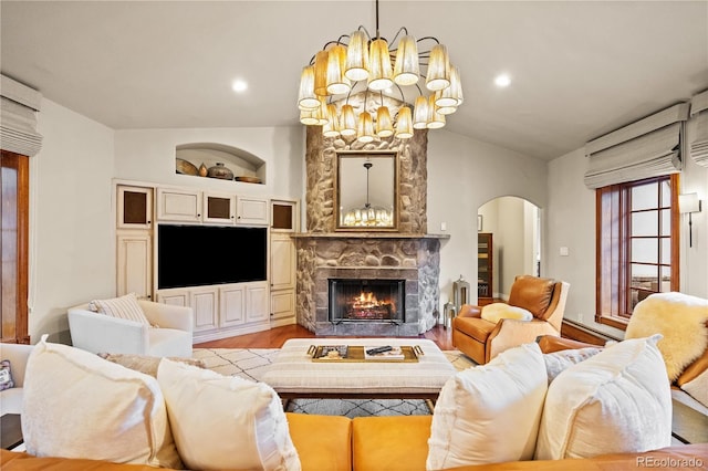 18 Club Ln, Littleton, CO 80123 - living room with wood finished floors, a fireplace, a notable chandelier, arched walkways, and lofted ceiling