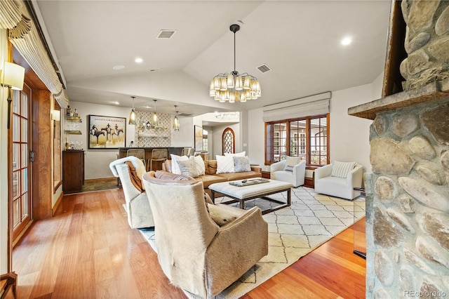 18 Club Ln, Littleton, CO 80123 - living area featuring a notable chandelier, wood finished floors, visible vents, and vaulted ceiling