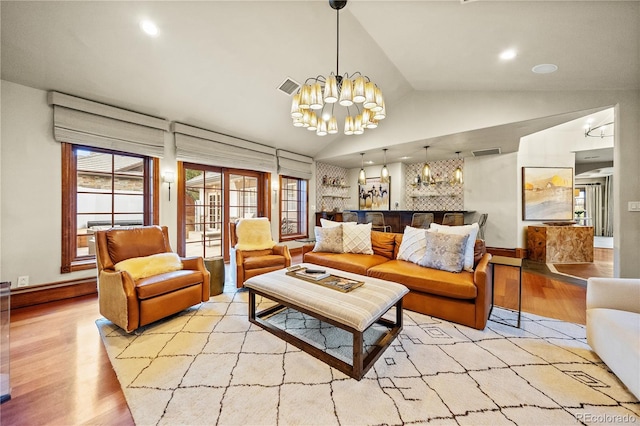 18 Club Ln, Littleton, CO 80123 - living room with vaulted ceiling, recessed lighting, visible vents, a chandelier, and wood finished floors
