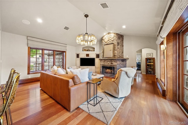 18 Club Ln, Littleton, CO 80123 - living area with vaulted ceiling, arched walkways, visible vents, and light wood-style floors