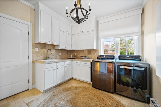 18 Club Ln, Littleton, CO 80123 - kitchen featuring a notable chandelier, washing machine and dryer, tasteful backsplash, light countertops, and white cabinets