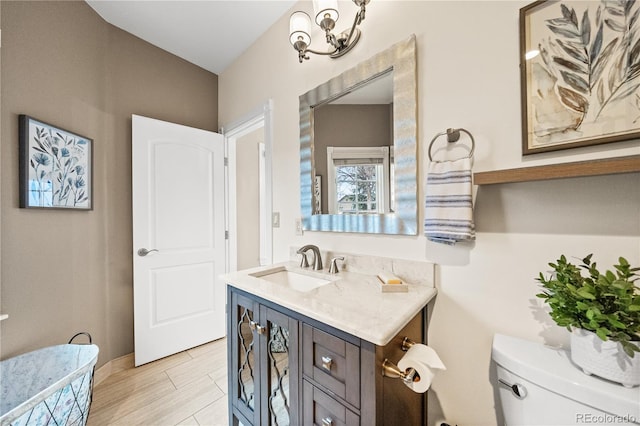 18 Club Ln, Littleton, CO 80123 - half bathroom with toilet, baseboards, and vanity