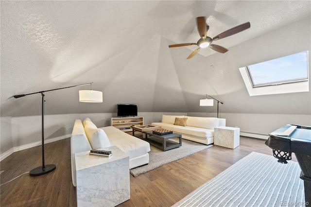 18 Club Ln, Littleton, CO 80123 - living room with wood finished floors, a ceiling fan, vaulted ceiling with skylight, baseboards, and baseboard heating