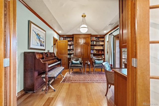 18 Club Ln, Littleton, CO 80123 - living area featuring light wood-type flooring, visible vents, built in features, vaulted ceiling, and crown molding
