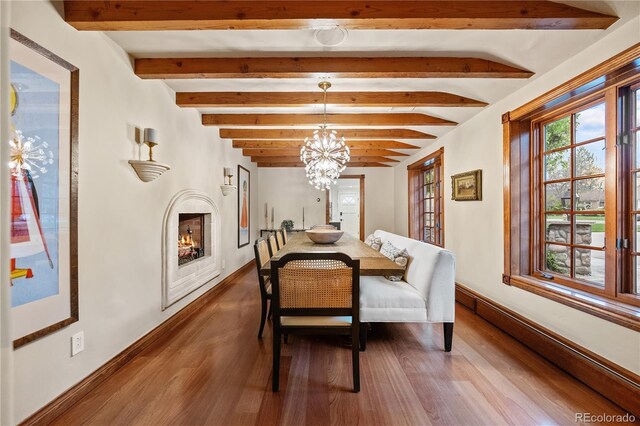 18 Club Ln, Littleton, CO 80123 - dining area featuring baseboards, dark wood finished floors, a chandelier, and a baseboard heating unit