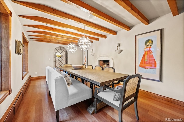 18 Club Ln, Littleton, CO 80123 - dining area with an inviting chandelier, beam ceiling, baseboards, and wood finished floors
