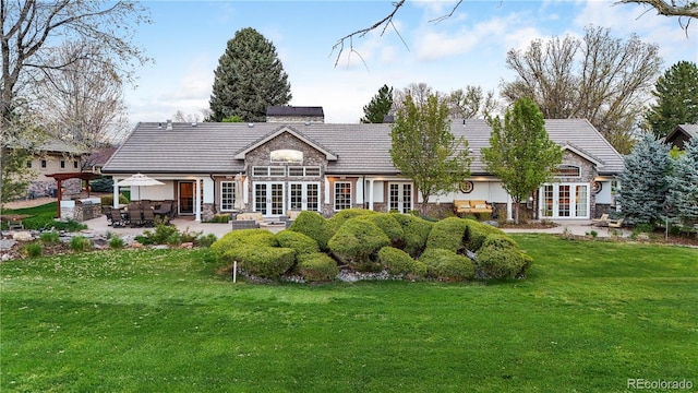 18 Club Ln, Littleton, CO 80123 - rear view of house with a lawn, stone siding, a patio area, and french doors