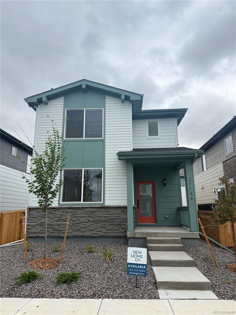 21144 E 63rd Dr, Aurora, CO 80019 - contemporary house featuring a porch and stone siding