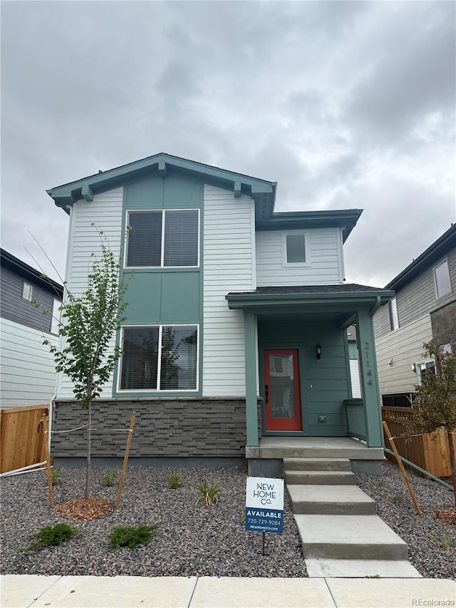 21144 E 63rd Dr, Aurora, CO 80019 - contemporary house featuring a porch and stone siding