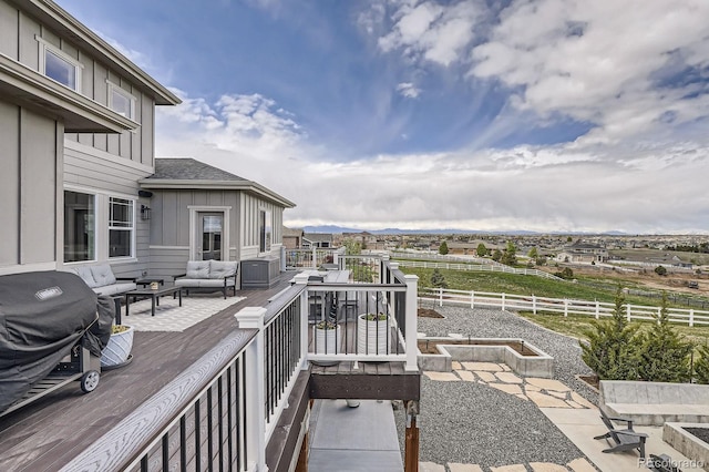 exterior space with outdoor lounge area, fence, and a wooden deck