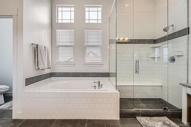 full bath featuring tile patterned flooring, a bath, toilet, and a shower stall