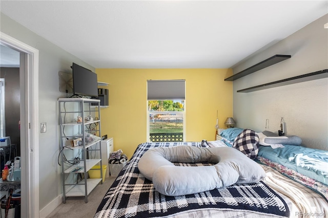 bedroom featuring carpet floors and baseboards