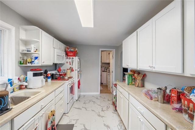 kitchen featuring white cabinets, white appliances, marble finish floor, and light countertops