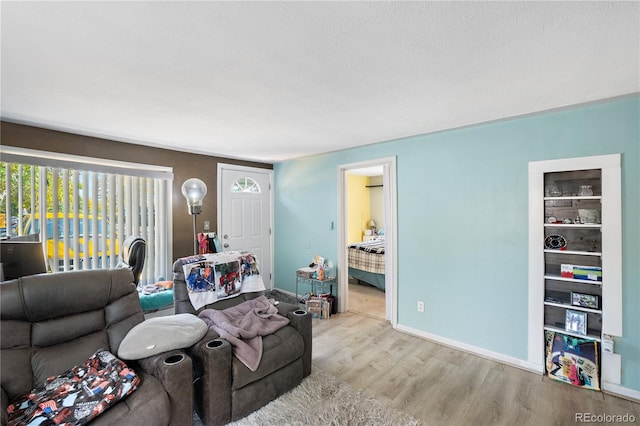 living room featuring light wood finished floors and baseboards